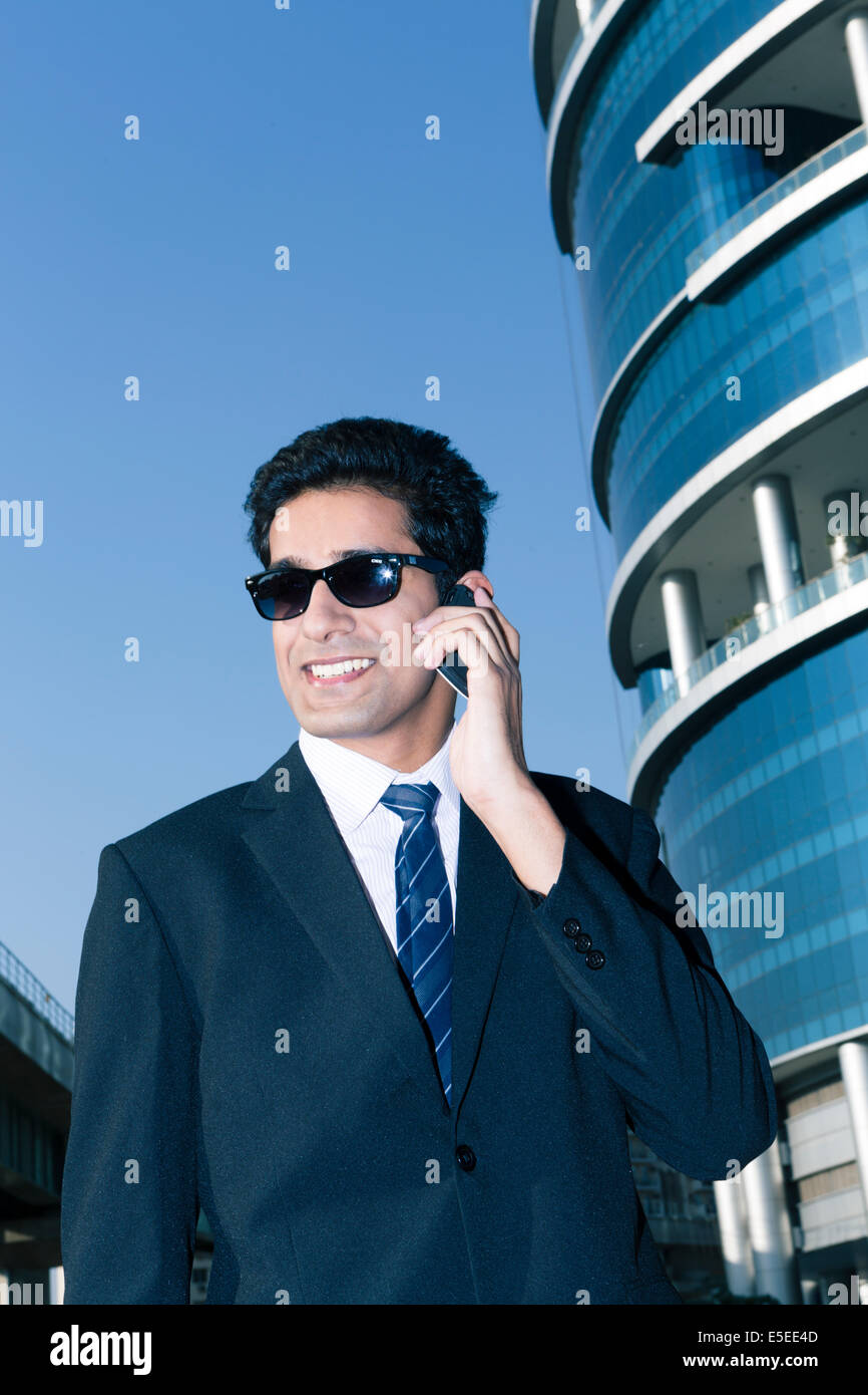 Indian business man with a mobile phone in the business sector of New Delhi, India Stock Photo