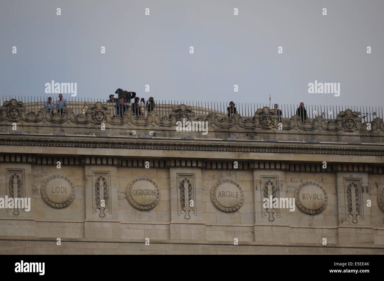 Journalists, soldiers on terrasse of Arc de Triomphe waiting for military parade on Avenue des Champs Elysees Bastille Day Paris Stock Photo