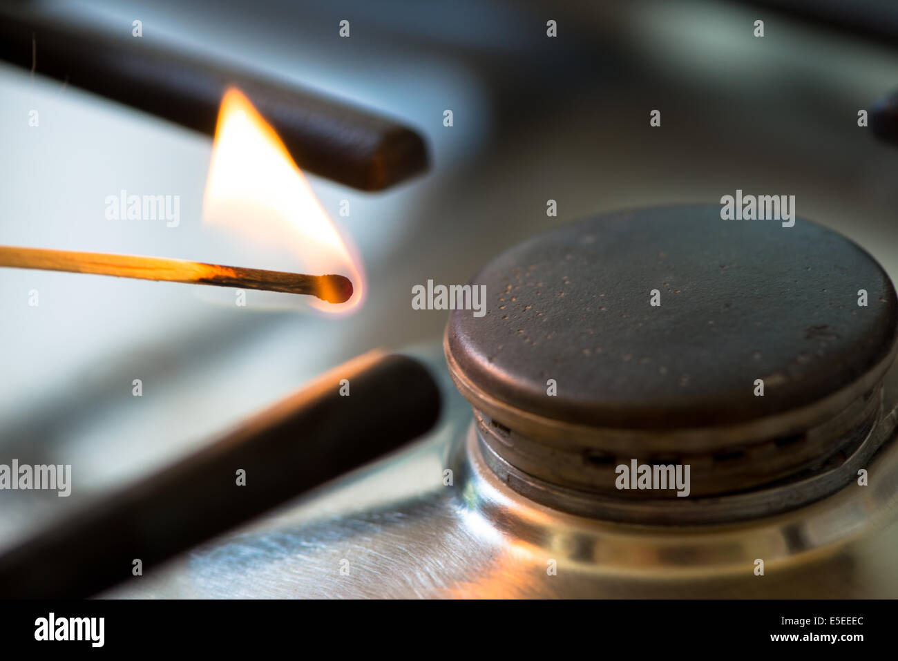 match lit the gas burner in the kitchen Stock Photo