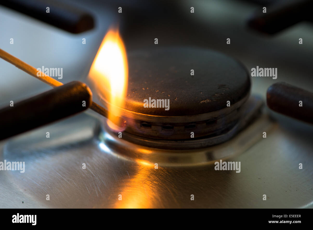match lit the gas burner in the kitchen Stock Photo