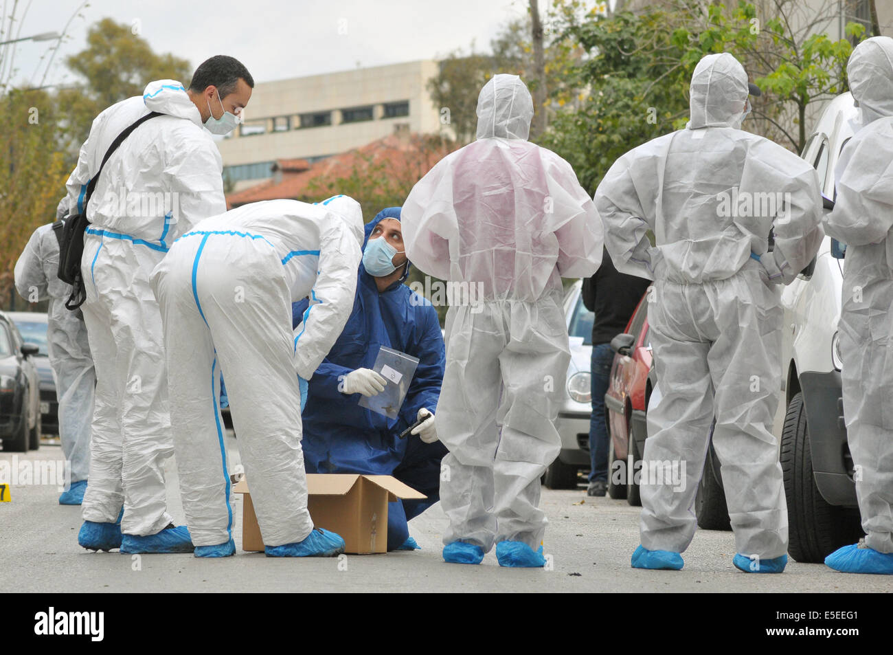 30 December 2010 - Athens, Greece - Forensic police officers gather evidence at the scene of a bomb attack on a court building i Stock Photo
