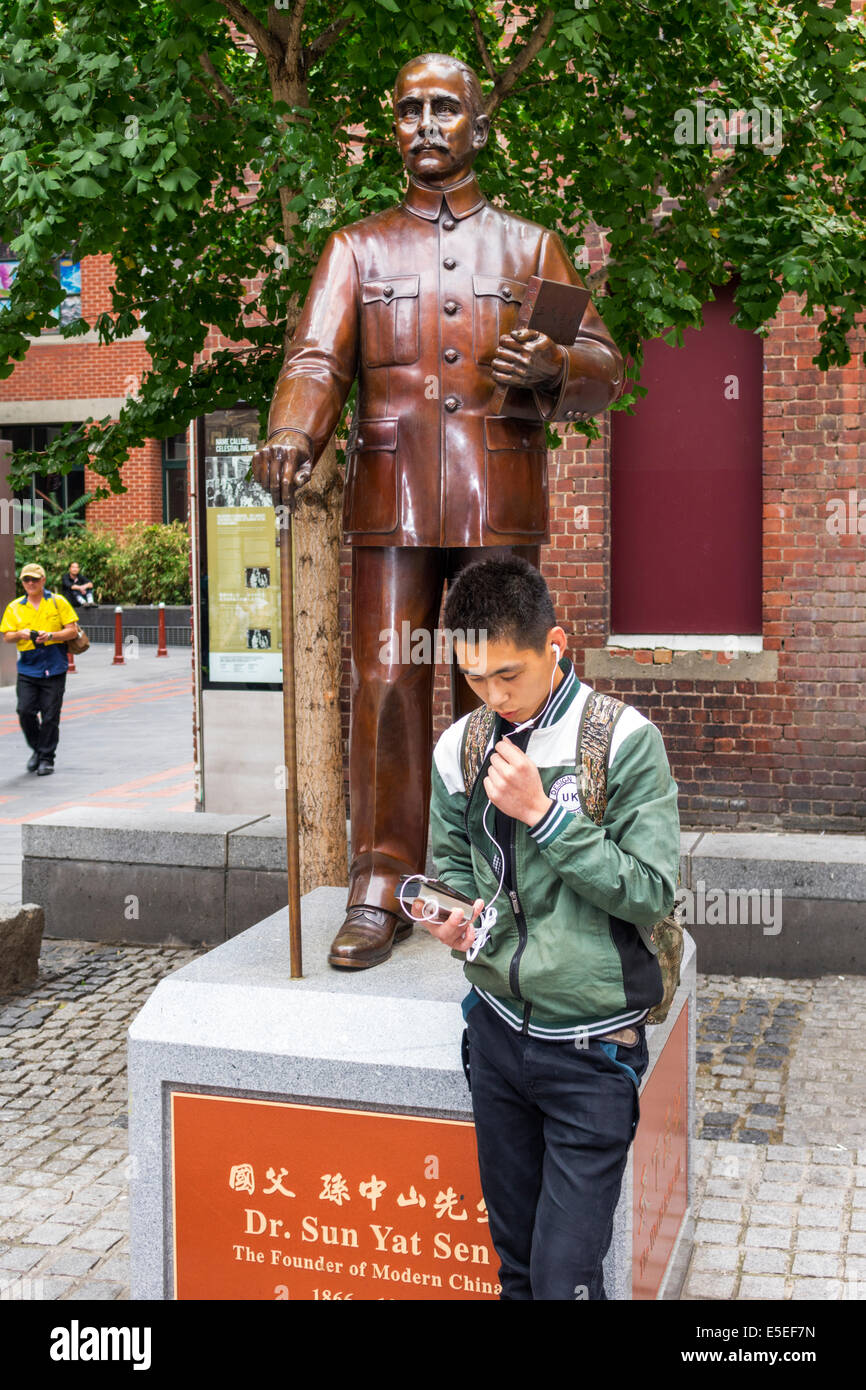 Melbourne Australia,Chinatown,Little Bourke Street,Asian boy boys,male kid kids child children youngster,teen ear bud,smartphone cell phone phones,che Stock Photo