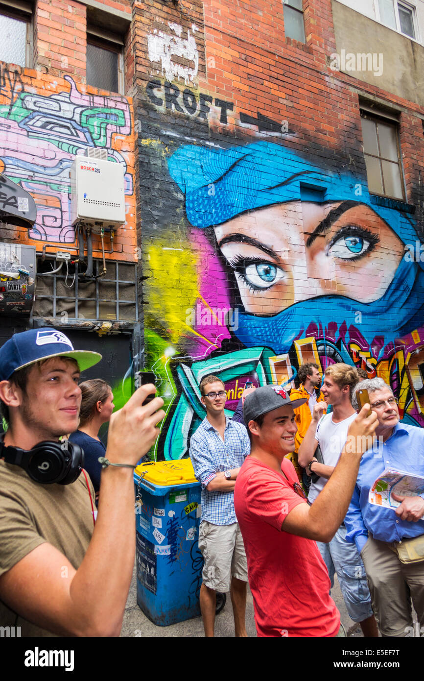 Melbourne Australia,Chinatown,Croft Alley,giant wall street mural,art,spray paint,man men male,taking mobile cell phone,phones,smartphone cell phone p Stock Photo