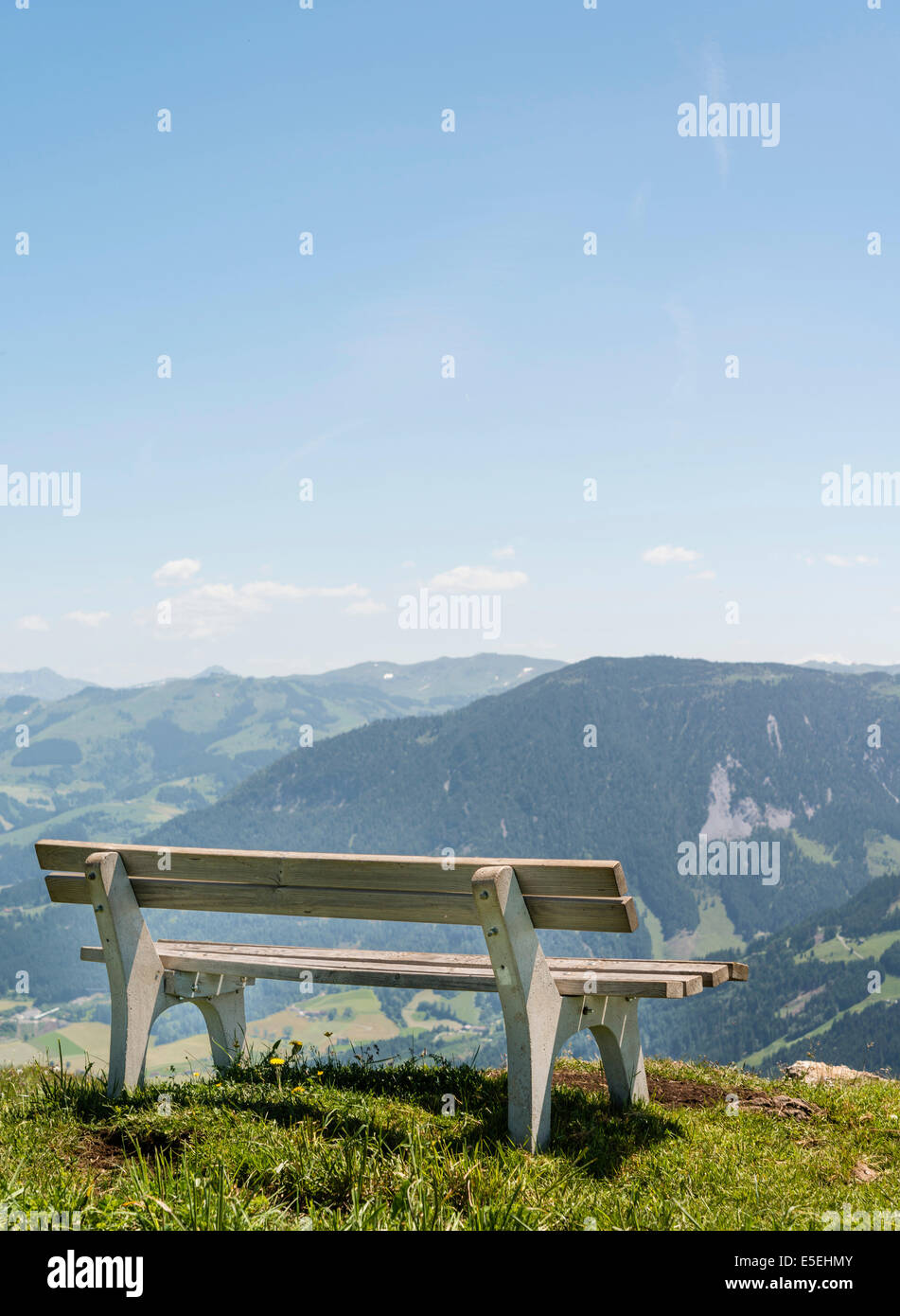 Wooden bench with views of the Alps, Brixen im Thale, Tyrol Austria Stock Photo