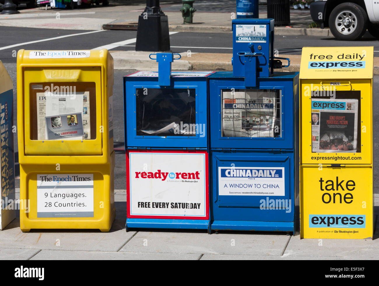 Colorful newspaper stands in Washington DC, USA holding free and paid newspapers including China Daily and Epoch Times Stock Photo