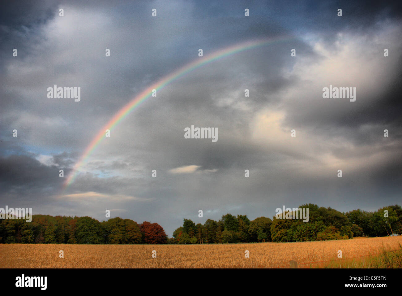 rainbow over a rural scene Stock Photo - Alamy