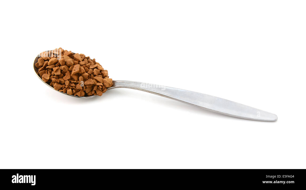 Metal teaspoon measure of instant coffee granules, isolated on a white background Stock Photo