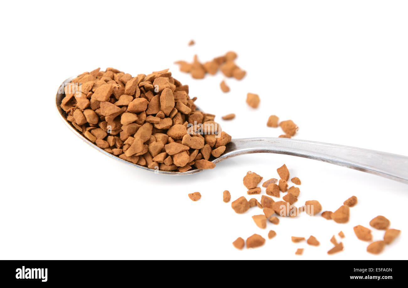 Closeup of a teaspoon of instant coffee granules, isolated on a white background Stock Photo