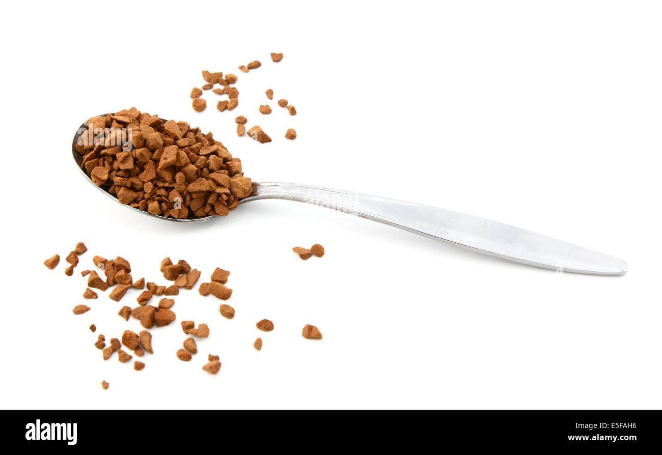 Teaspoon of instant coffee with some granules spilled around the spoon, isolated on a white background Stock Photo