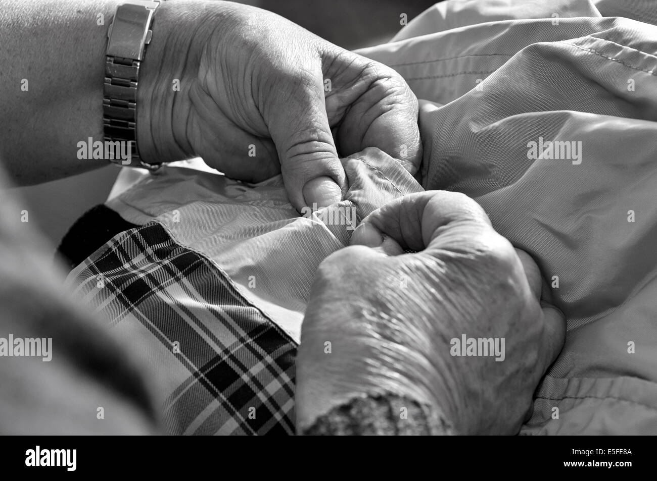 Old woman sewing Stock Photo