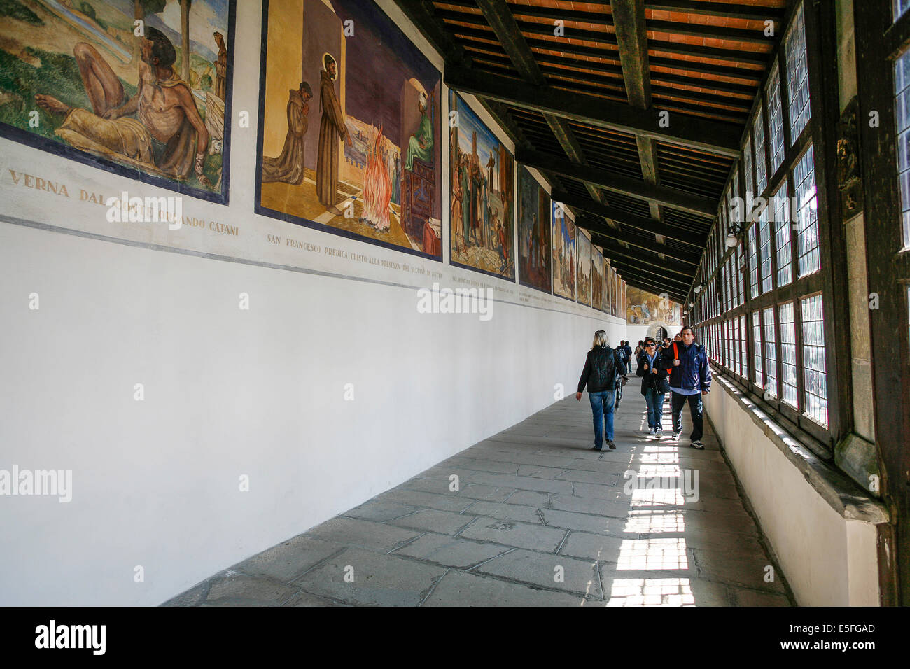 Tuscany La Verna (AR): Corridor of the Stigmata: faithful who look at paintings depicting episodes from the life of St. Francis Stock Photo