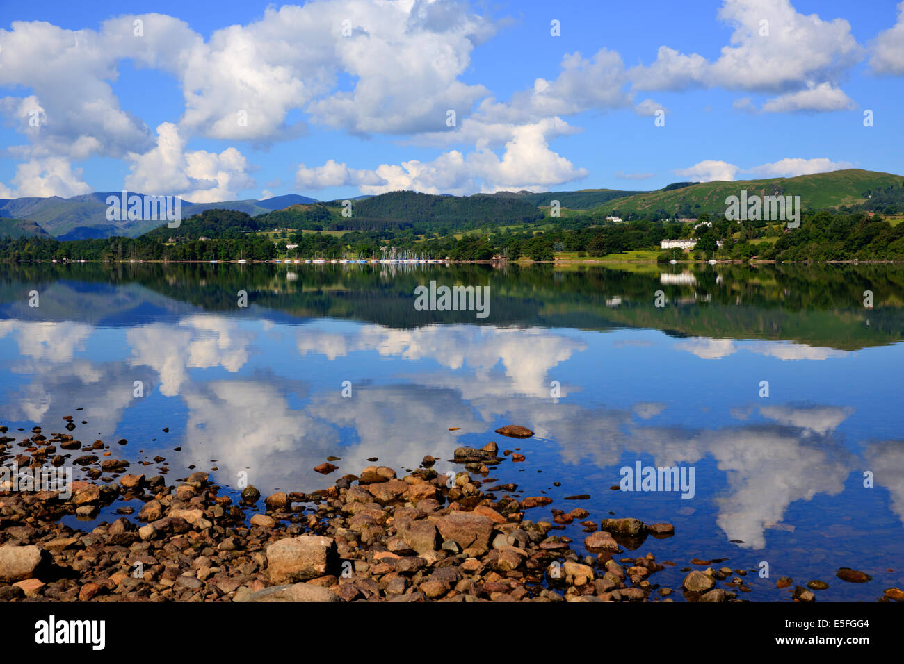 English countryside lake District Ullswater with mountains and blue sky on beautiful still summer day with reflections Stock Photo