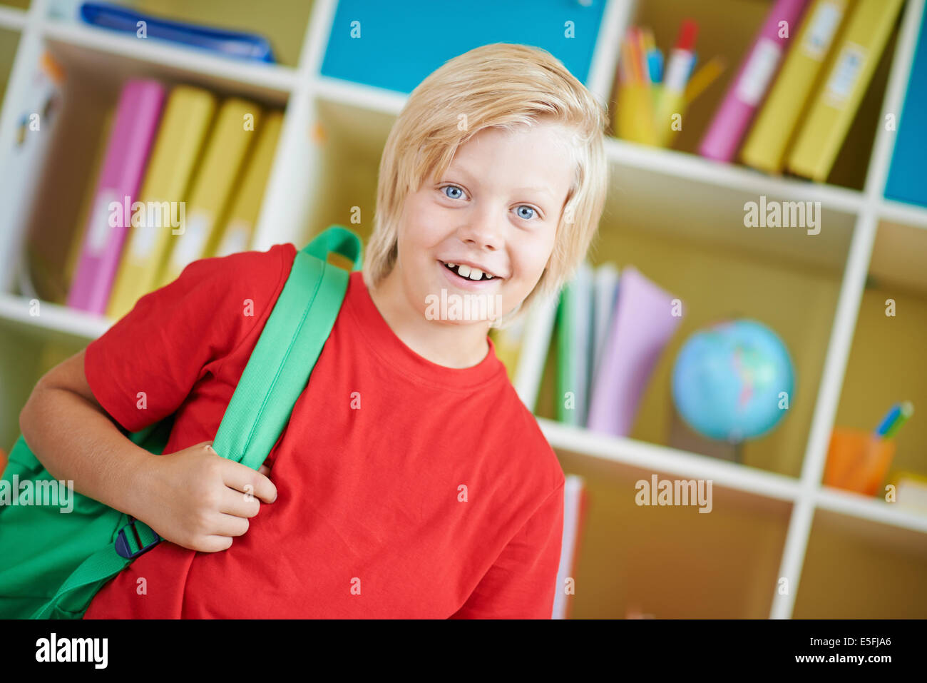 Portrait of a cute schoolboy with backpack looking at camera Stock ...