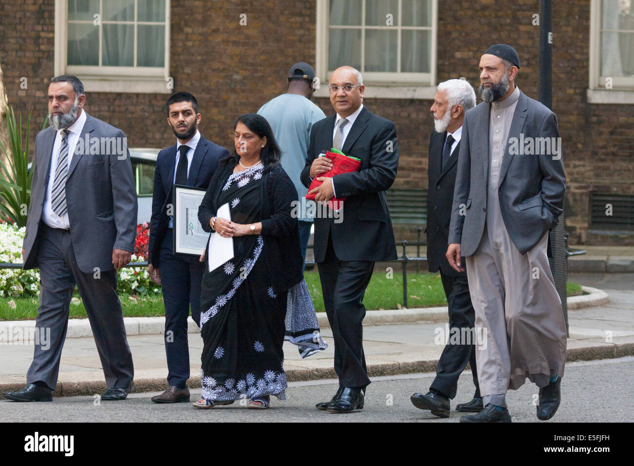 London, UK. 30th July, 2014. . Representatives from the Federation of Muslim Organisations from Leicestershire accompanied by Keith Vaz MP, Leicester East, deliver a 'Palestinian Peace Flag' signed by hundreds, calling on the Prime Minister to help encourage an immediate ceasefire in the Israeli-Palestinian conflict. Credit:  Paul Davey/Alamy Live News Stock Photo