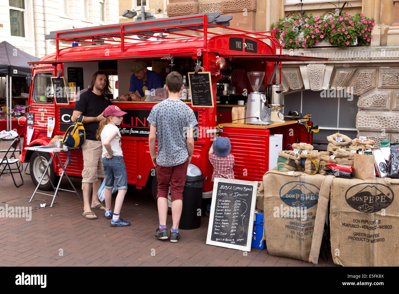 Family buying drinks from a coffee van in Ipswich market square. Stock Photo