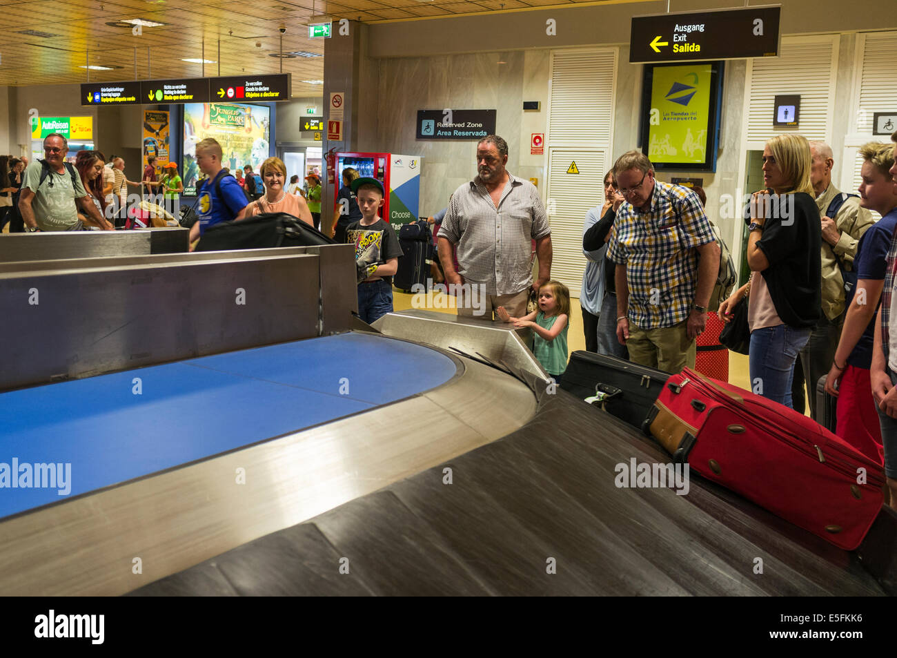 Arriving passengers waiting for their cases at baggage claim in Tenerife Airport, Canary Islands, Spain. Stock Photo