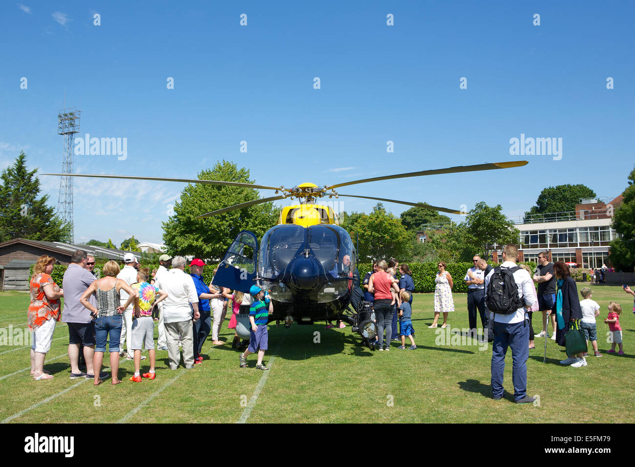 Imber Court police sports club, Ember Road, East Molesey, Surrey, UK. 29th July, 2014.  the Metropolitan Police helicopter (twin engine EC145 Eurocopter) lands as part of the entertainment for visitors to the Howorth Trophy day. This is a cricket match played by teams from different Metropolitan police departments and stations in commemoration of the death of Ken Howorth (GM - George Medal).  Ken was a bomb disposal officer killed whilst diffusing an IRA bomb in central London in 1981. Credit:  Emma Durnford/Alamy Live News Stock Photo