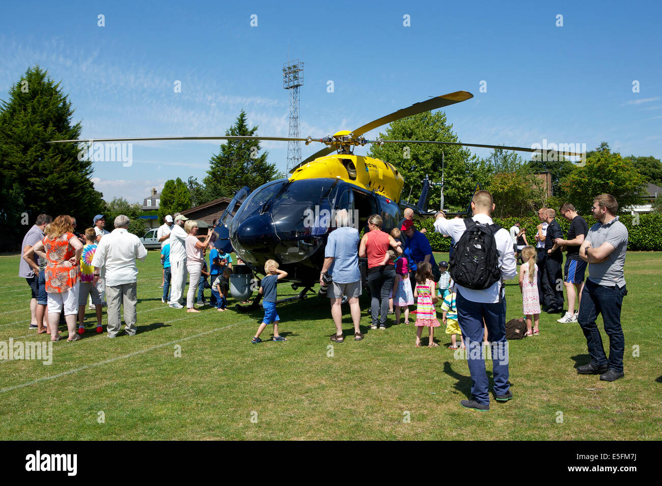 Imber Court police sports club, Ember Road, East Molesey, Surrey, UK. 29th July, 2014.  the Metropolitan Police helicopter (twin engine EC145 Eurocopter) lands as part of the entertainment for visitors to the Howorth Trophy day. This is a cricket match played by teams from different Metropolitan police departments and stations in commemoration of the death of Ken Howorth (GM - George Medal).  Ken was a bomb disposal officer killed whilst diffusing an IRA bomb in central London in 1981. Credit:  Emma Durnford/Alamy Live News Stock Photo