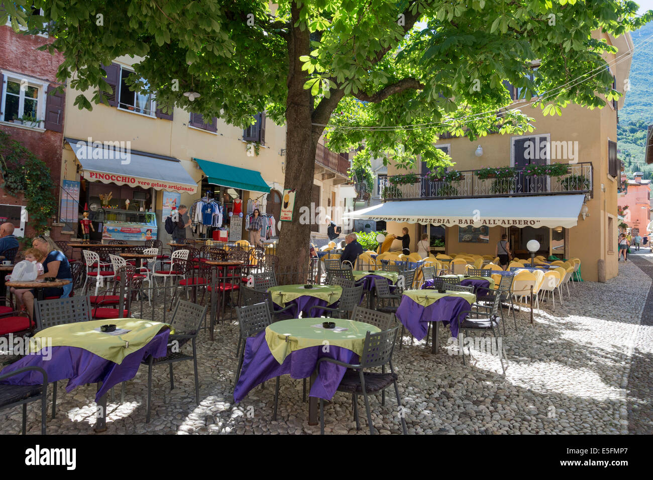 Square with restaurants, Malcesine, Verona province, Veneto, Italy Stock Photo