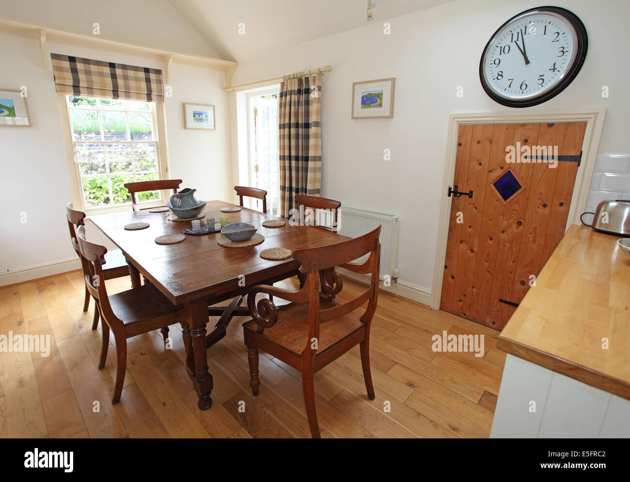 wooden table and chairs in a traditional cottage dining room. Stock Photo