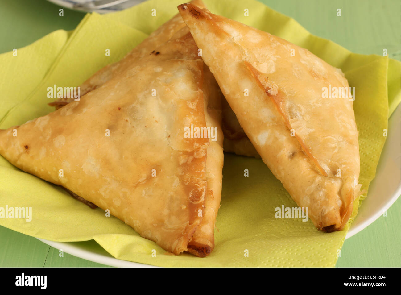 Samosas a spicy blend of vegetables or meat wrapped in a deep fried triangular pastry parcel Stock Photo