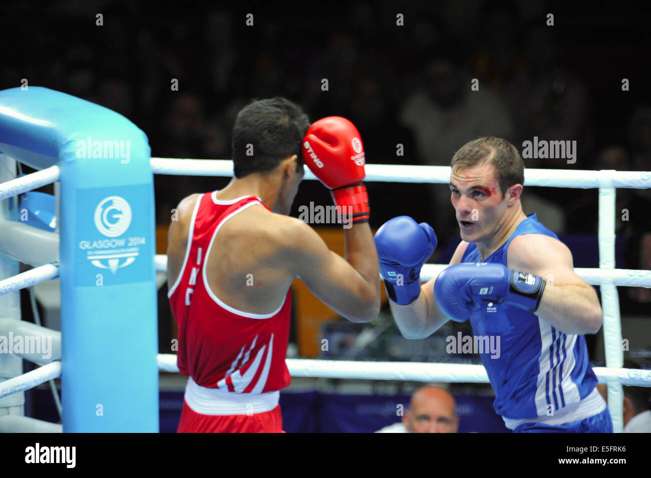 Glasgow, Scotland, UK. 30th July, 2014. Stephen Lavelle (SCO, blue) and Amritpreet Sin (IND, red) boxing in the 91kg quarter finals at the XX Commonwealth Games, Glasgow. The match was won by Lavelle with a score of 88 points to 82. Credit:  Michael Preston/Alamy Live News Stock Photo