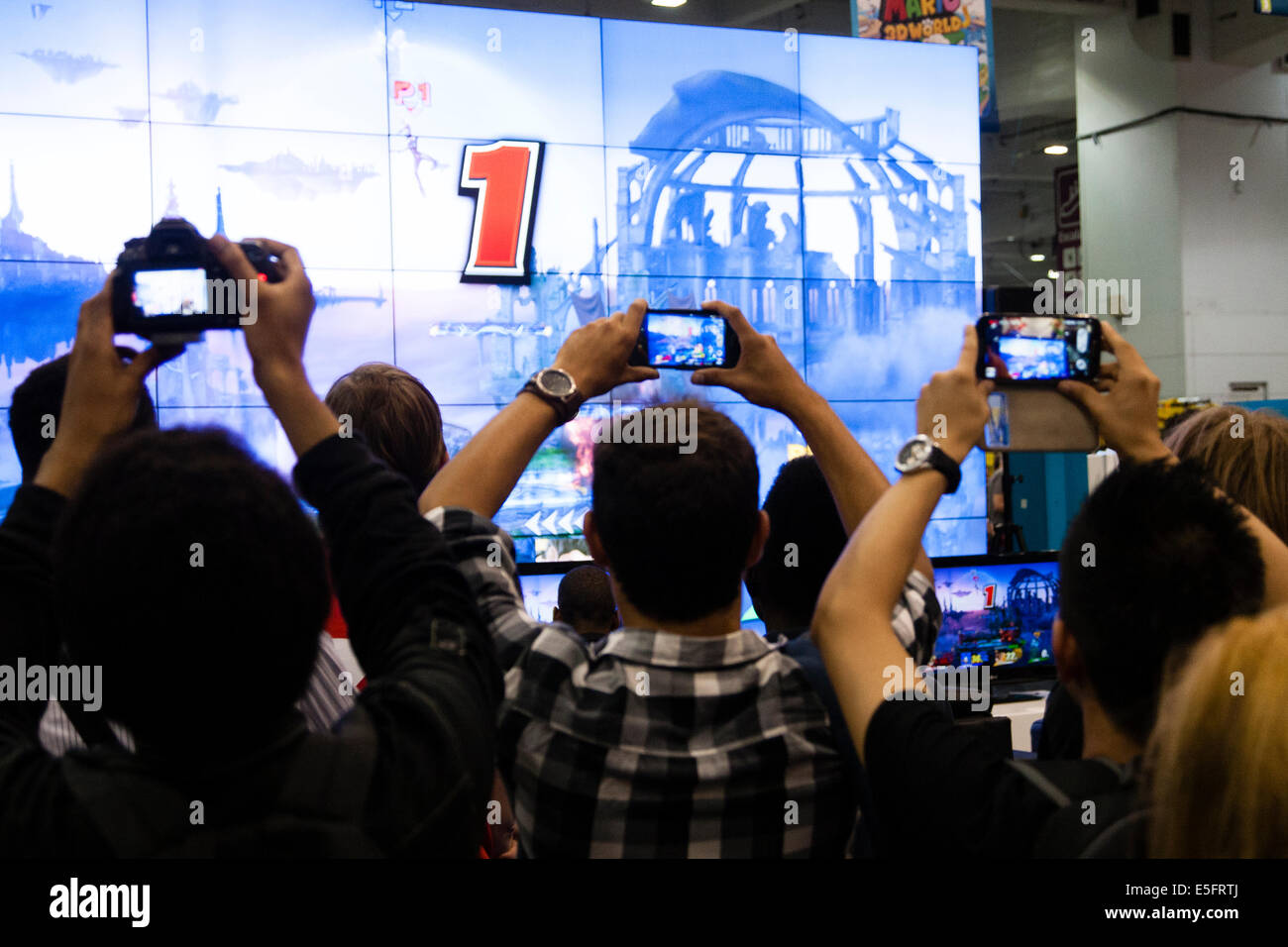 LONDON, ENGLAND The crowd takes photographs of video games at Hyper Japan at Ears Court. Stock Photo