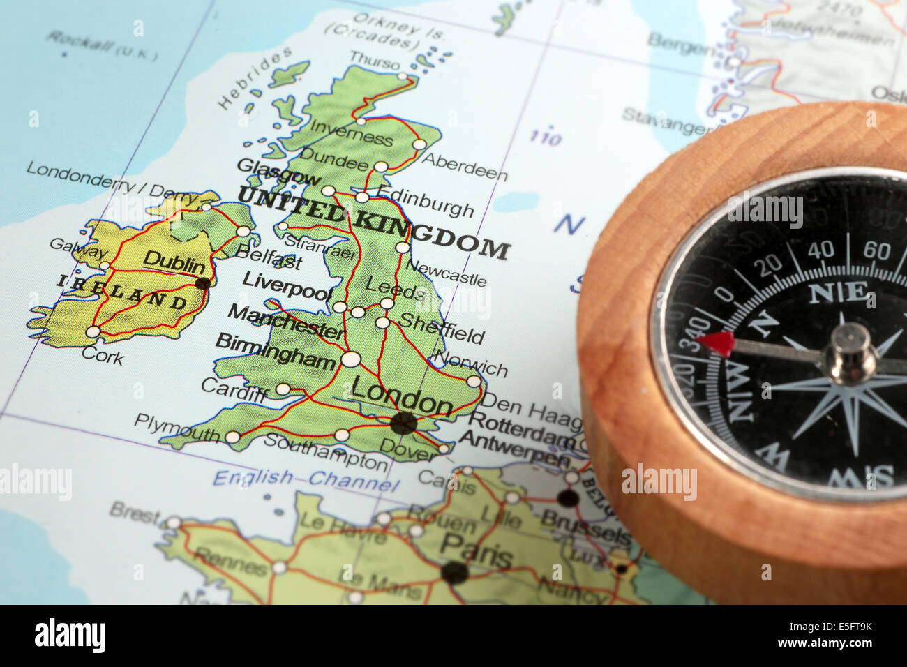 Compass on a map pointing at United Kingdom and Ireland, planning a travel destination Stock Photo