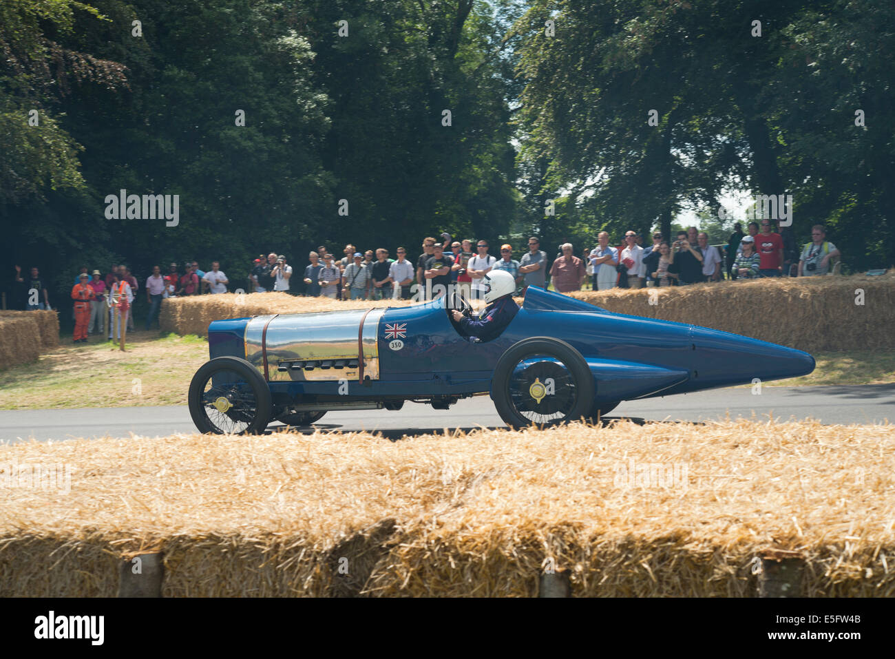 Car descending the Goodwood Hill Climb at Goodwood Festival of Speed Stock Photo
