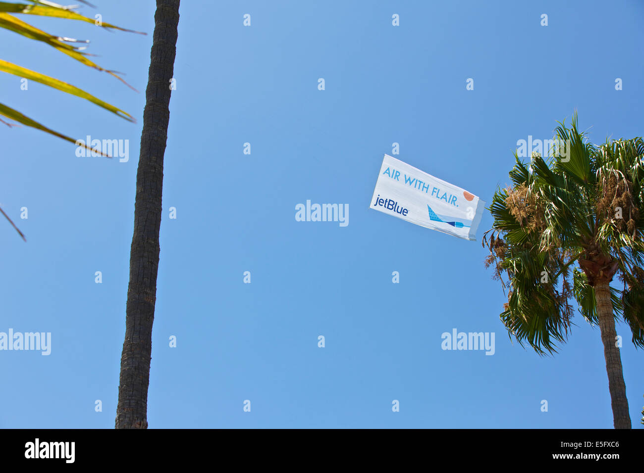 Banner Towing Aircraft Tows Aerial Advert Over Long Beach Waterfront On A Summer Weekend. Stock Photo