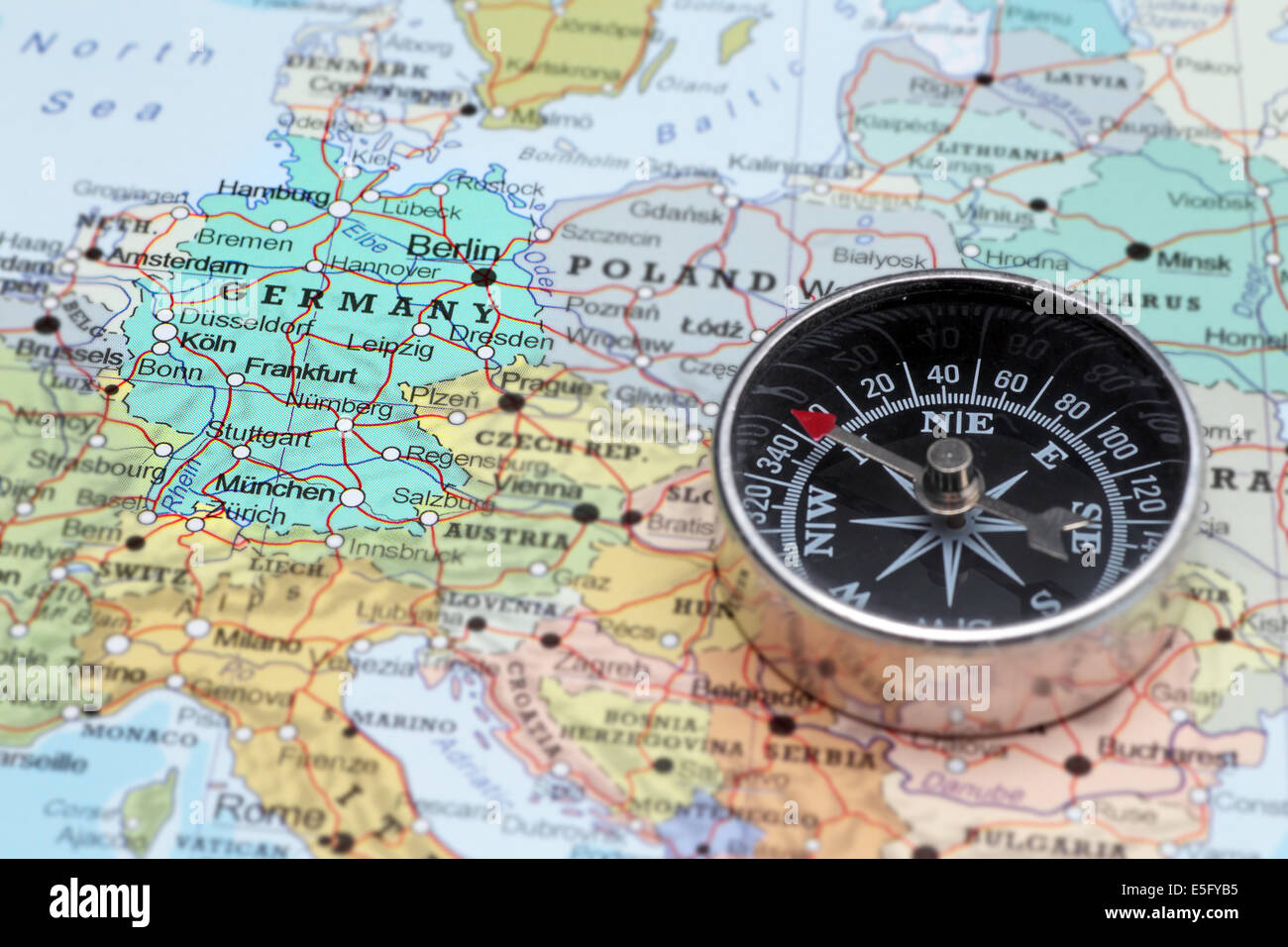 Compass on a map pointing at Germany and planning a travel destination Stock Photo