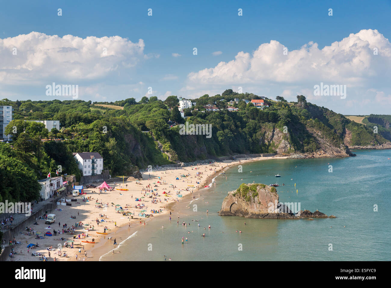 North beach in Tenby packed full of holidaymakers - pictured with Goscar Rock looking towards the north. Tourism in Wales Stock Photo