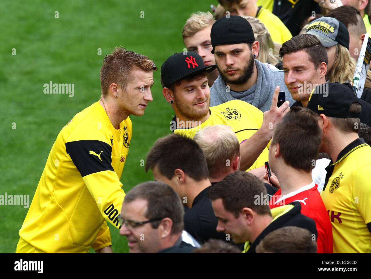 Bad Ragaz, Switzerland. 30th July, 2014. Marco Reus of Borussia Dortmund poses for photographs with fans after the training of Borussia Dortmund in Bad Ragaz, Switzerland, 30 July 2014. The Bundesliga team prepares in a training camp in Bad Ragaz for the next season until 06 August 2014. Photo: Karl-Josef Hildenbrand/dpa/Alamy Live News Stock Photo