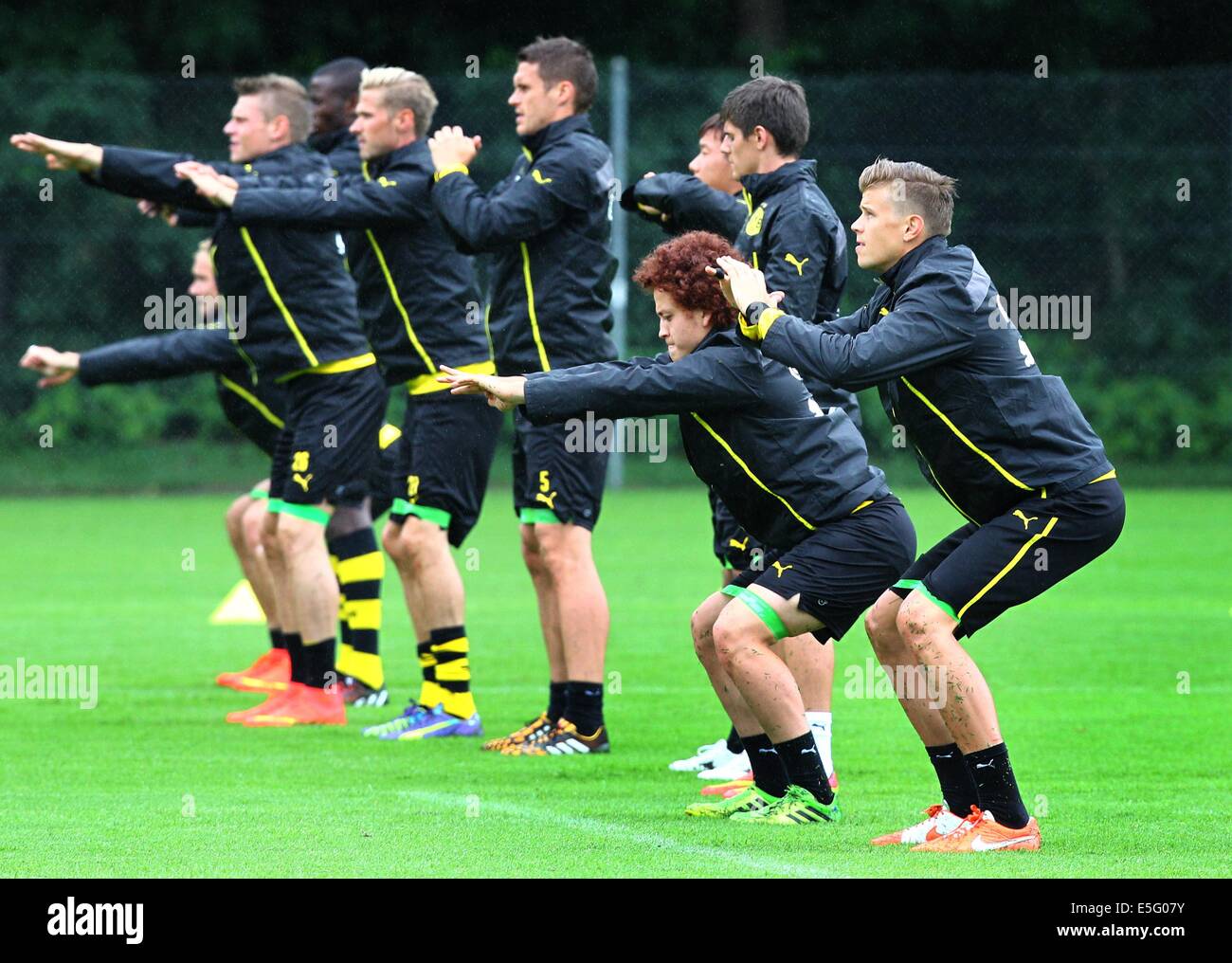 Bad Ragaz, Switzerland. 30th July, 2014. Goal keeper Mitchell Langerak (R), Mustafa Amini (3-R) and other players of Borussia Dortmund poses for photographs with fans after the training of Borussia Dortmund in Bad Ragaz, Switzerland, 30 July 2014. The Bundesliga team prepares in a training camp in Bad Ragaz for the next season until 06 August 2014. Photo: Karl-Josef Hildenbrand/dpa/Alamy Live News Stock Photo