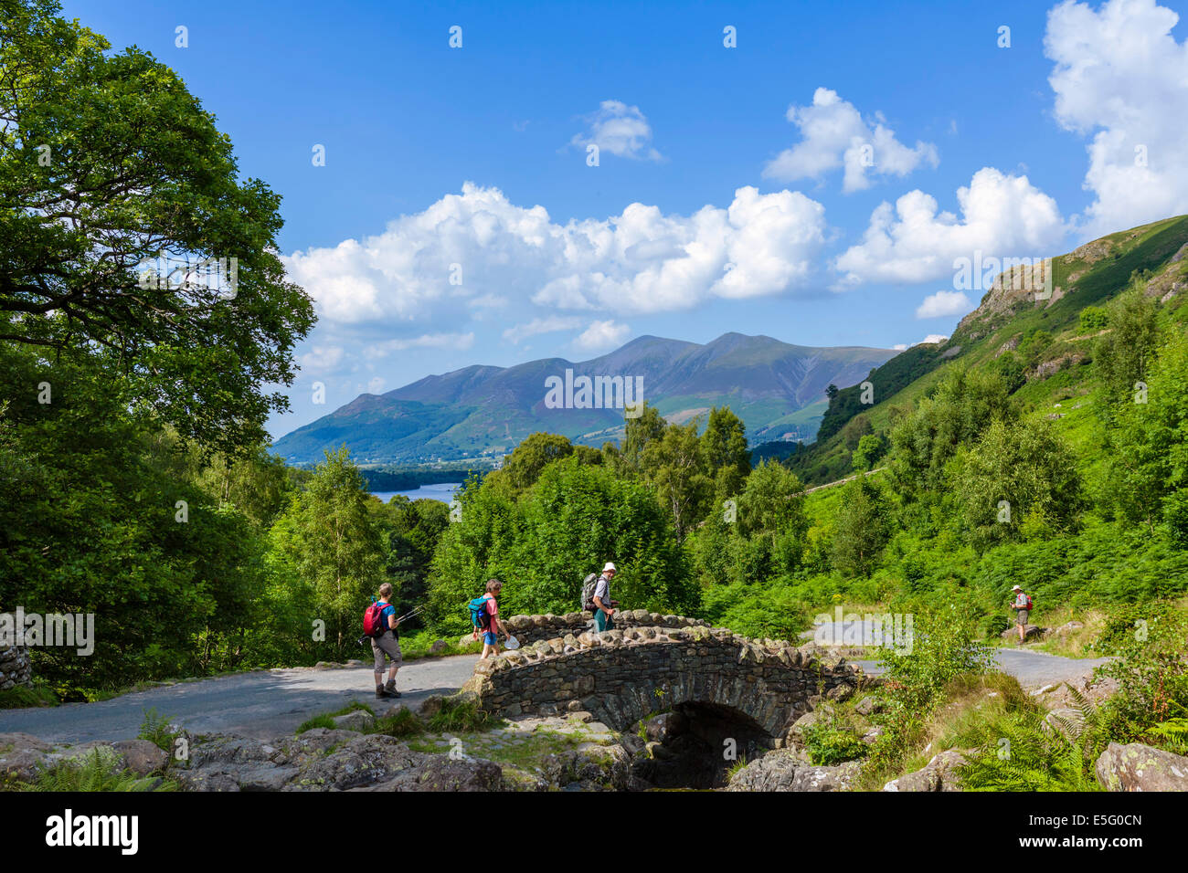 English Lake District. Walkers at Ashness Bridge with Skiddaw massif in the distance, Borrowdale, Lake District National Park, Cumbria, UK Stock Photo