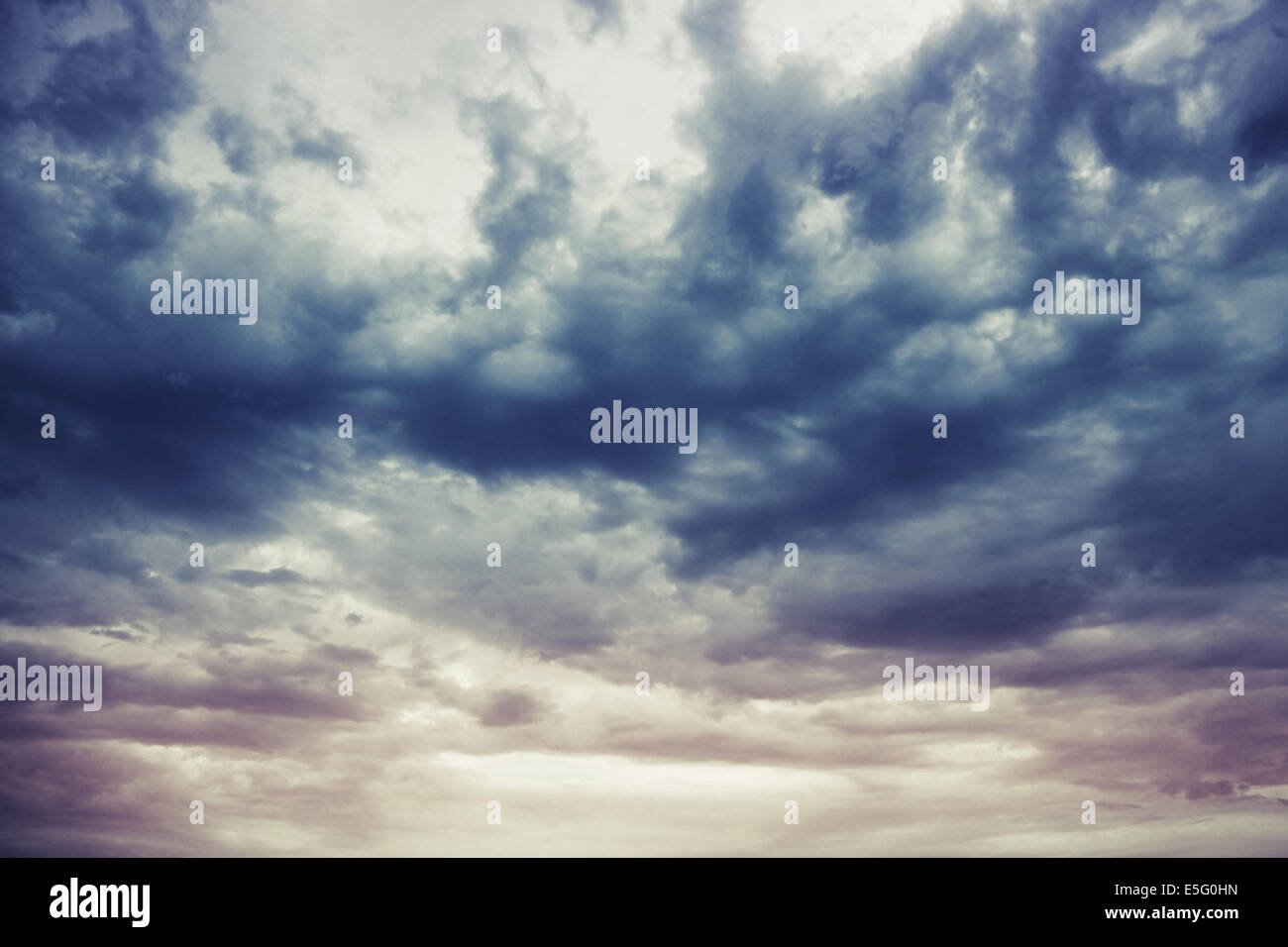Dark blue stormy cloudy sky natural photo background Stock Photo - Alamy