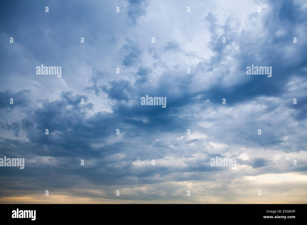 Dark blue stormy cloudy sky natural photo background Stock Photo
