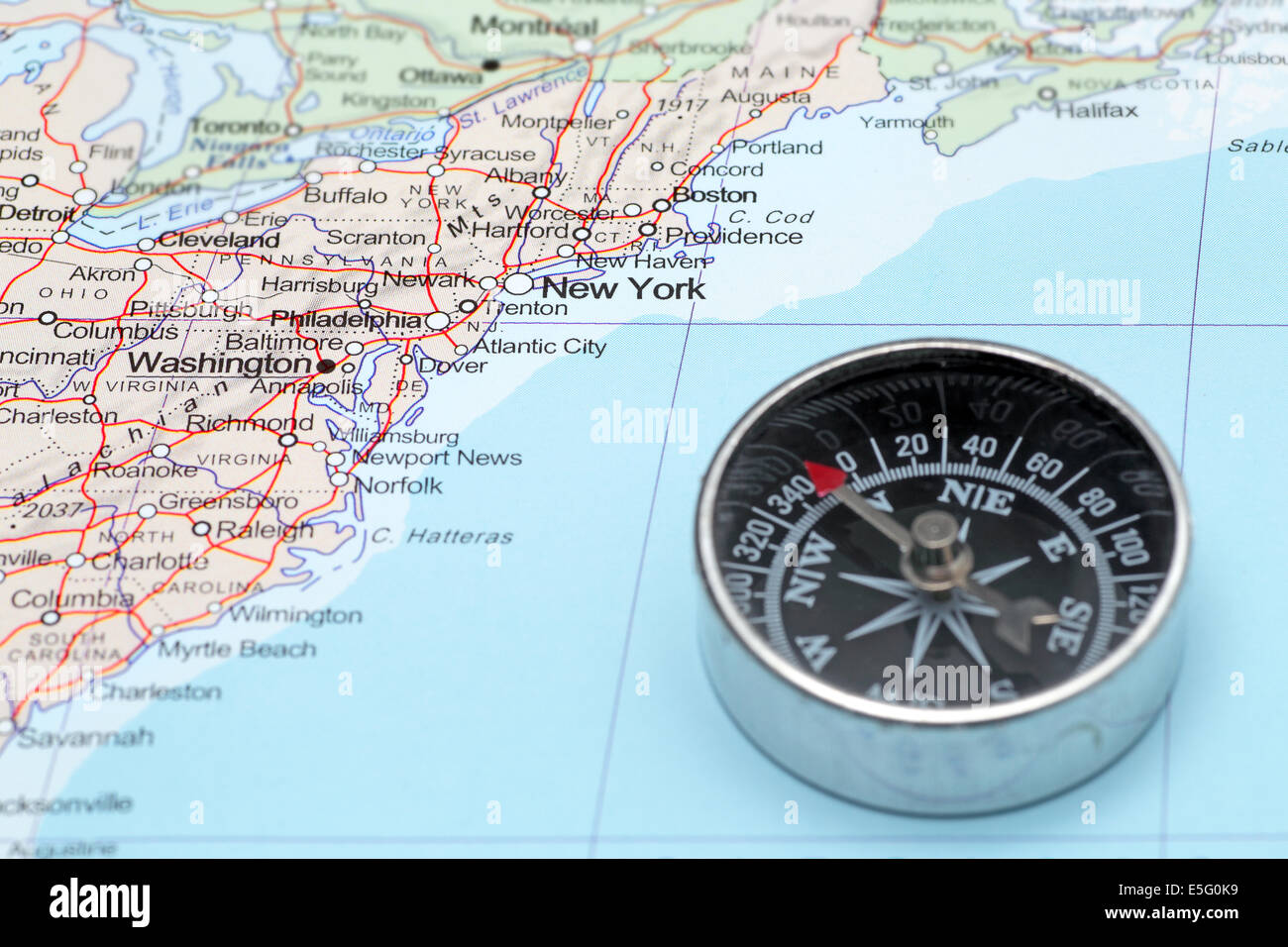 Compass on a map pointing at United States and planning a travel with destination New York Stock Photo