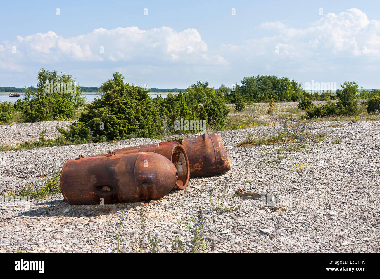 Several old rusty marine mines on the ground Stock Photo