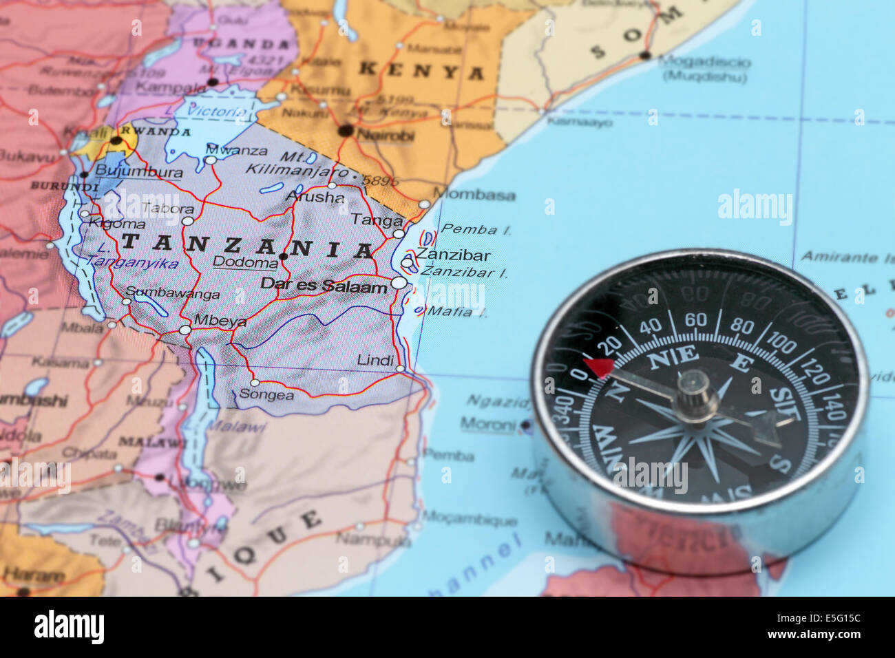 Compass on a map pointing at Tanzania and planning a travel destination Stock Photo