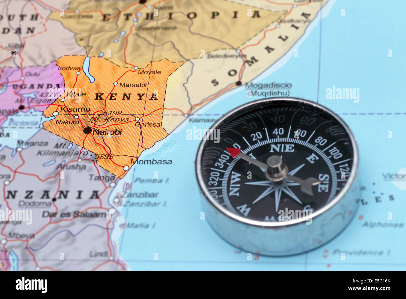 Compass on a map pointing at Kenya and planning a travel destination Stock Photo