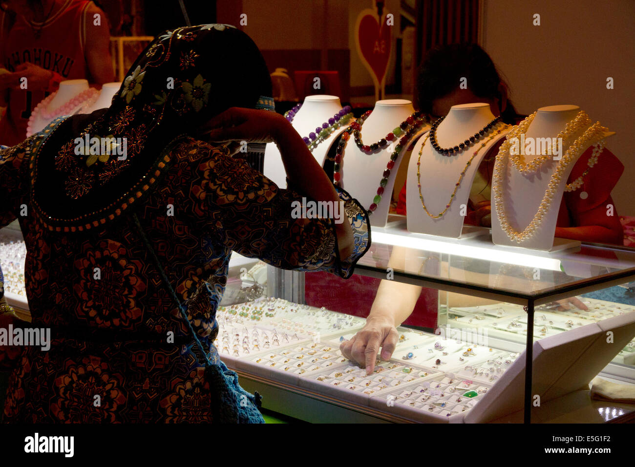 Woman picking jewelry Stock Photo
