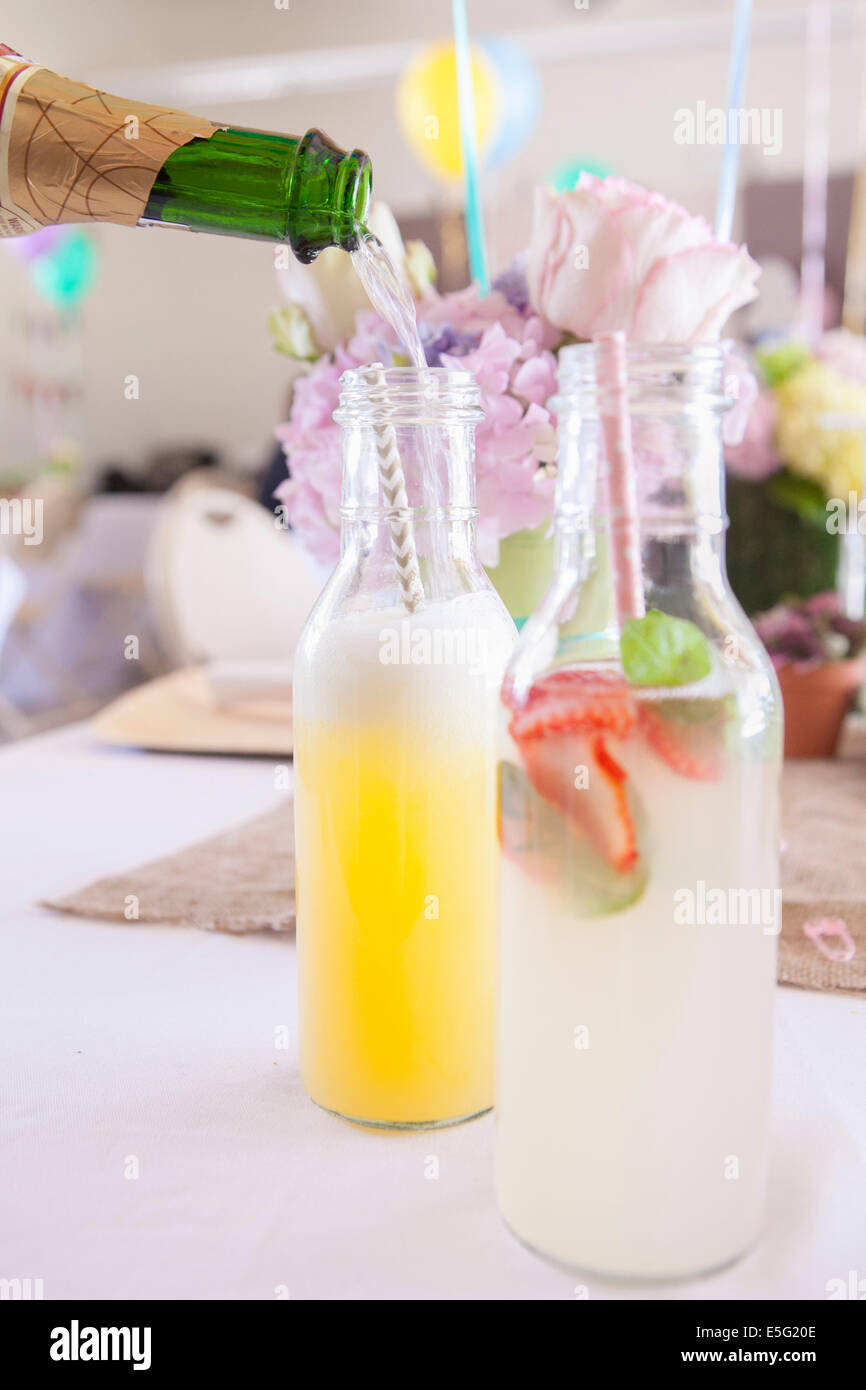 Pouring alcohol into bottle with drinking straw Stock Photo Alamy
