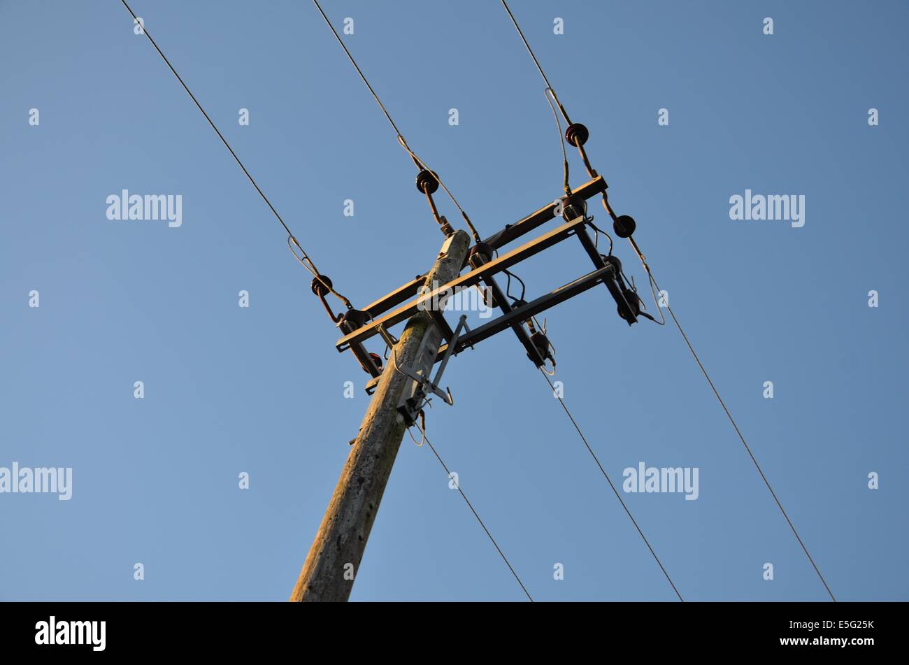 Electricity Power Lines Against A Blue Sky Stock Photo - Alamy