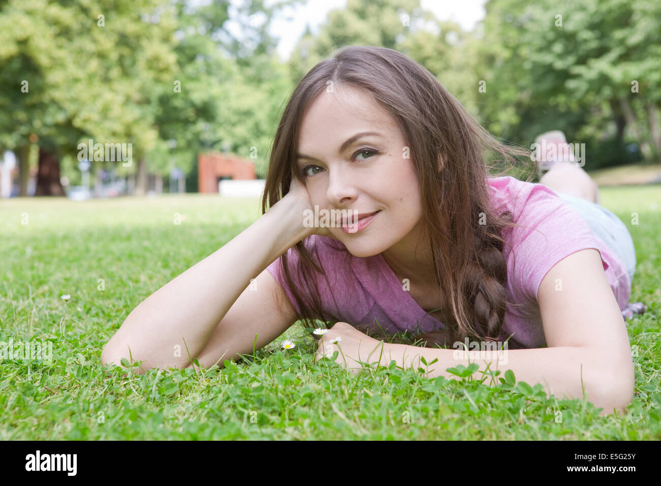 Woman lying on a meadow Stock Photo