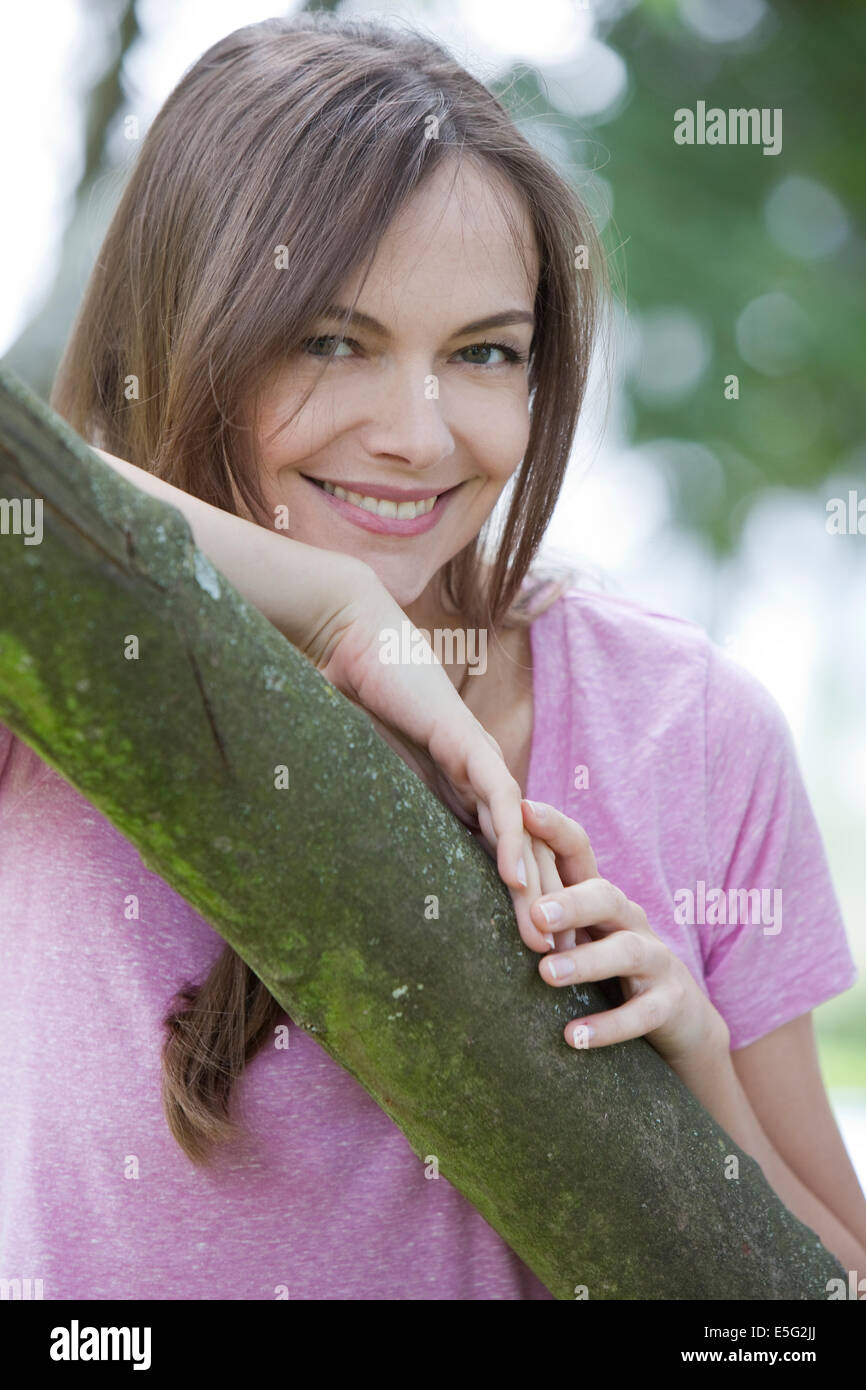 Portrait of a woman at a tree Stock Photo