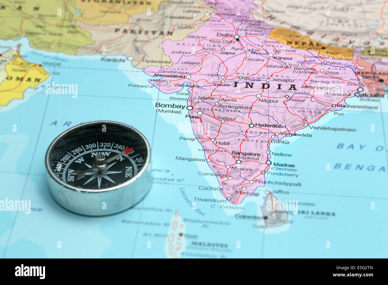 Compass on a map pointing at India and planning a travel destination Stock Photo