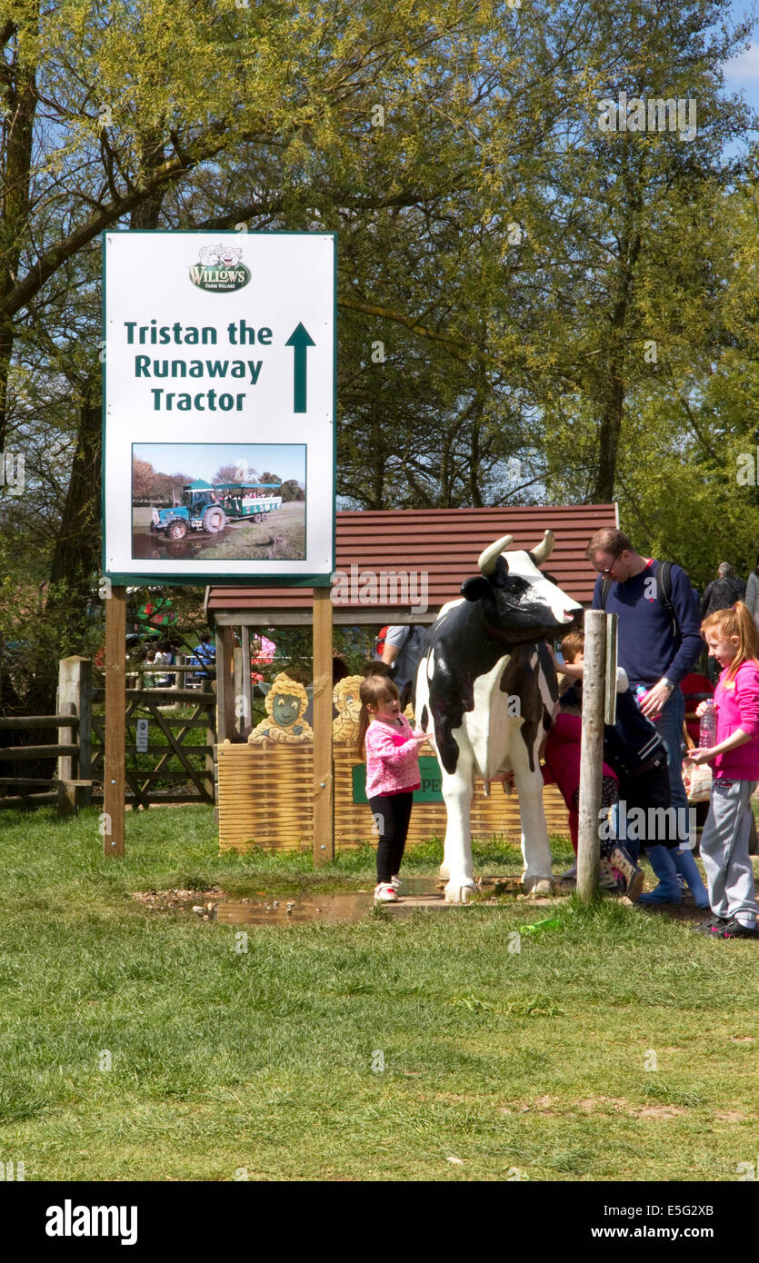 Children with 'Daisy the (model) Milking Cow' , Willows Activity Farm, London Colney, St Albans, Hertfordshire, UK Stock Photo