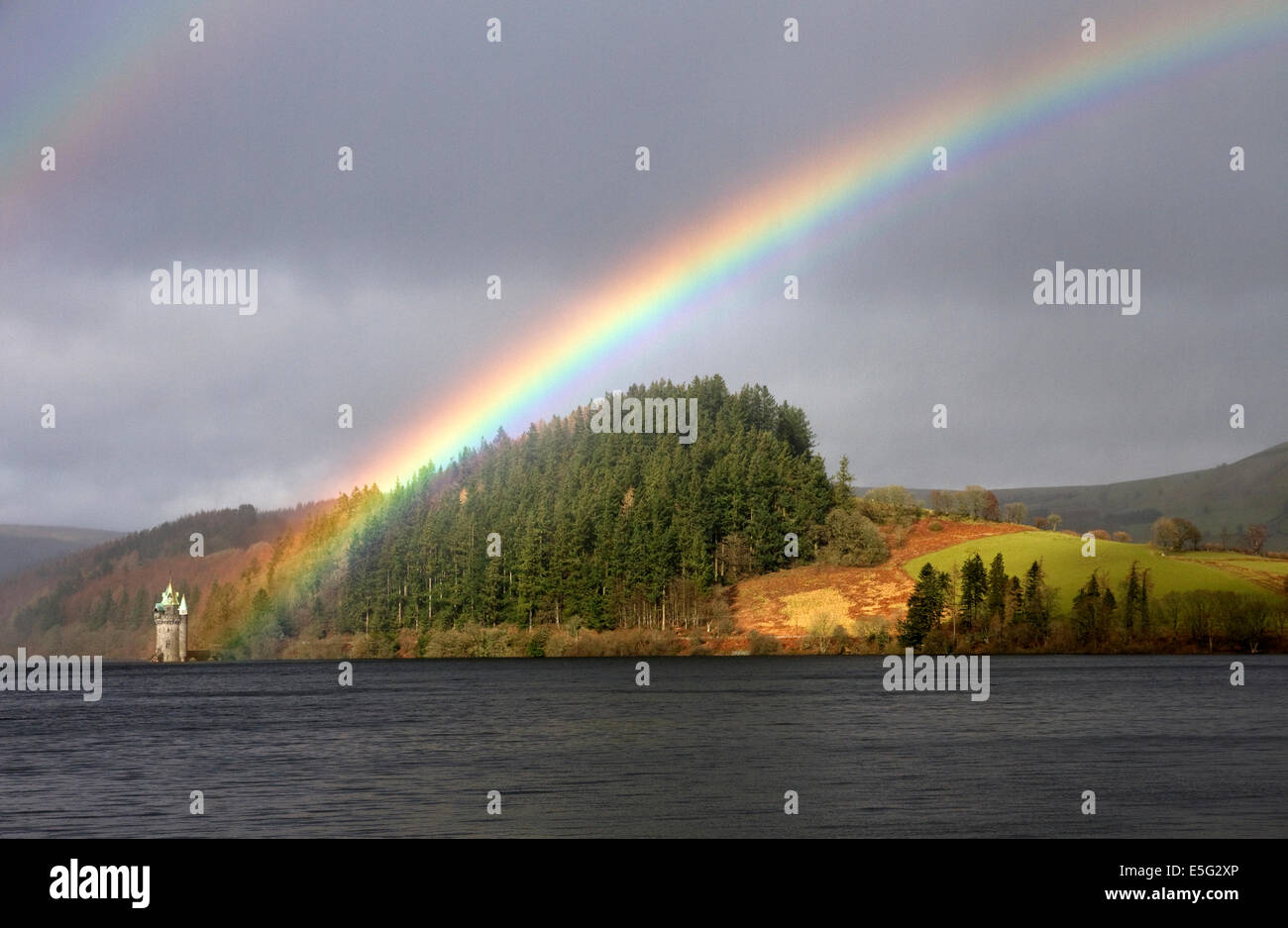Rainbow highlights the gothic Straining Tower on Lake Vyrnwy (Victorian reservoir) Montgomeryshire, Powys, Wales, UK Stock Photo