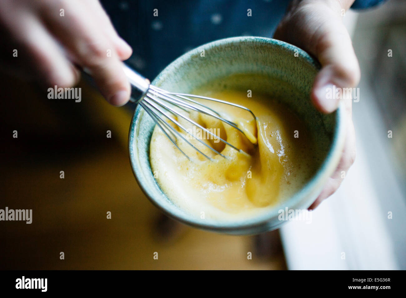 Close-up view of woman whisking Stock Photo